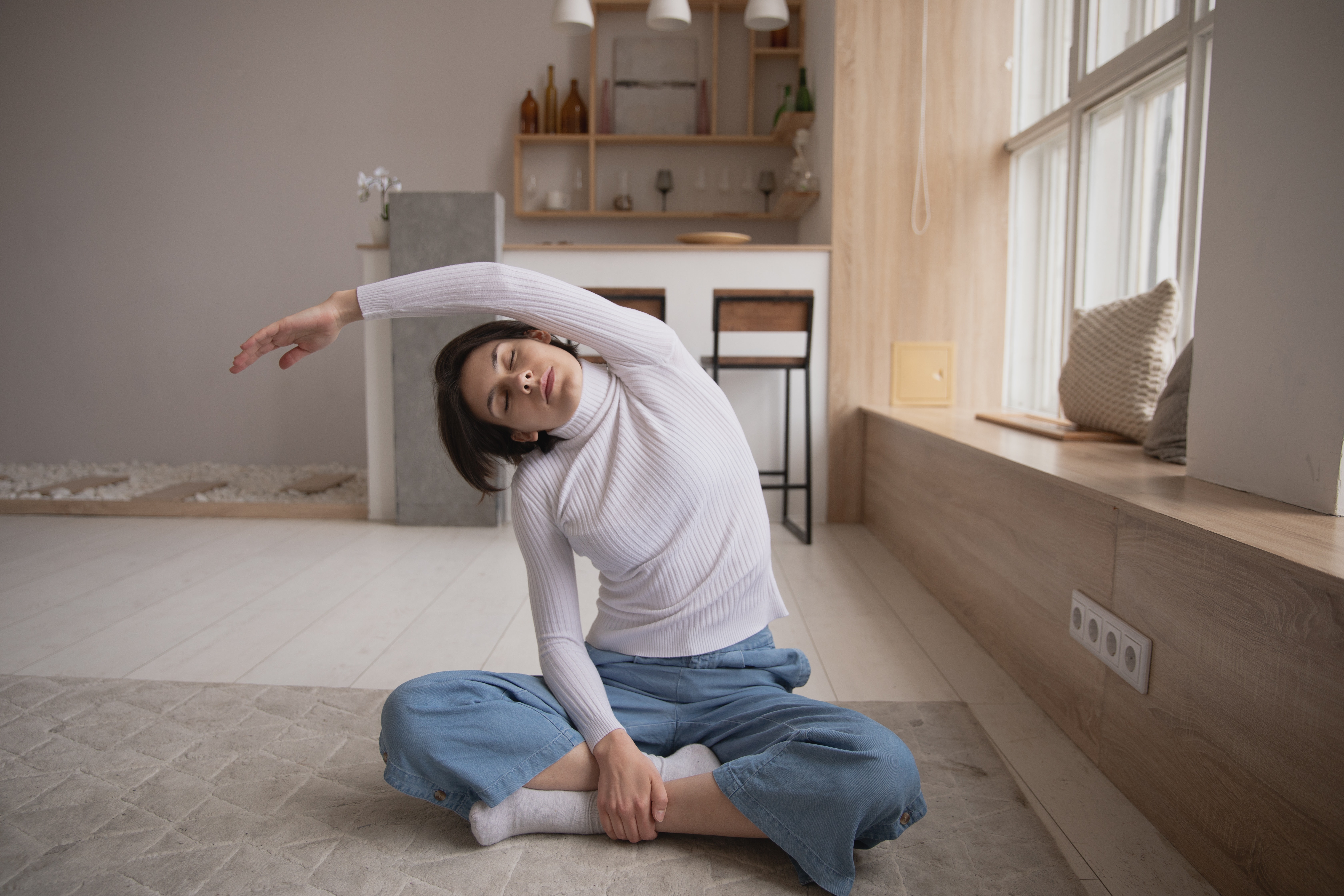woman stretching on her floor