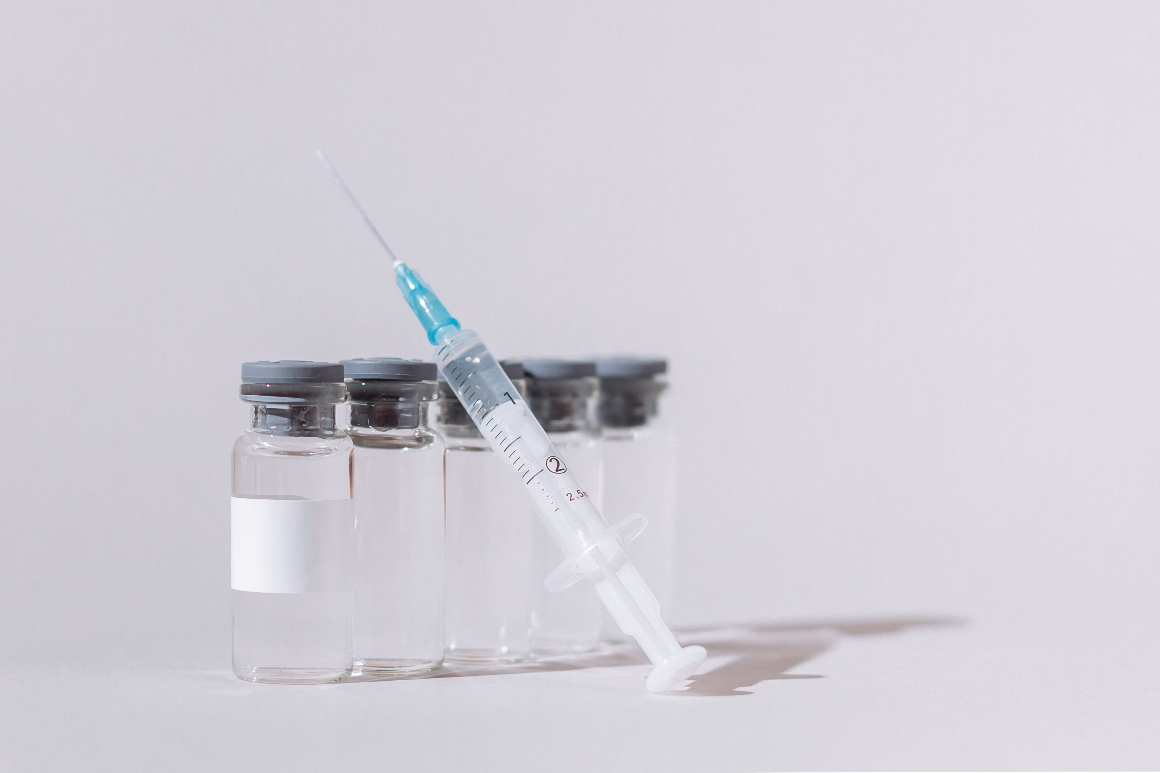 bottles with vaccine and a needle