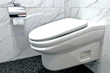 white toilet in a bathroom with with white marble walls and a silver toilet paper holder