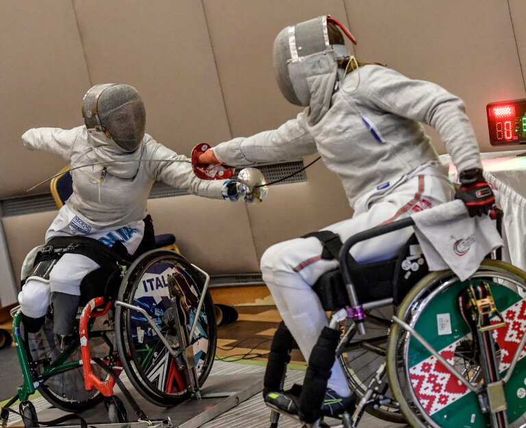 two boys fencing in wheelchairs