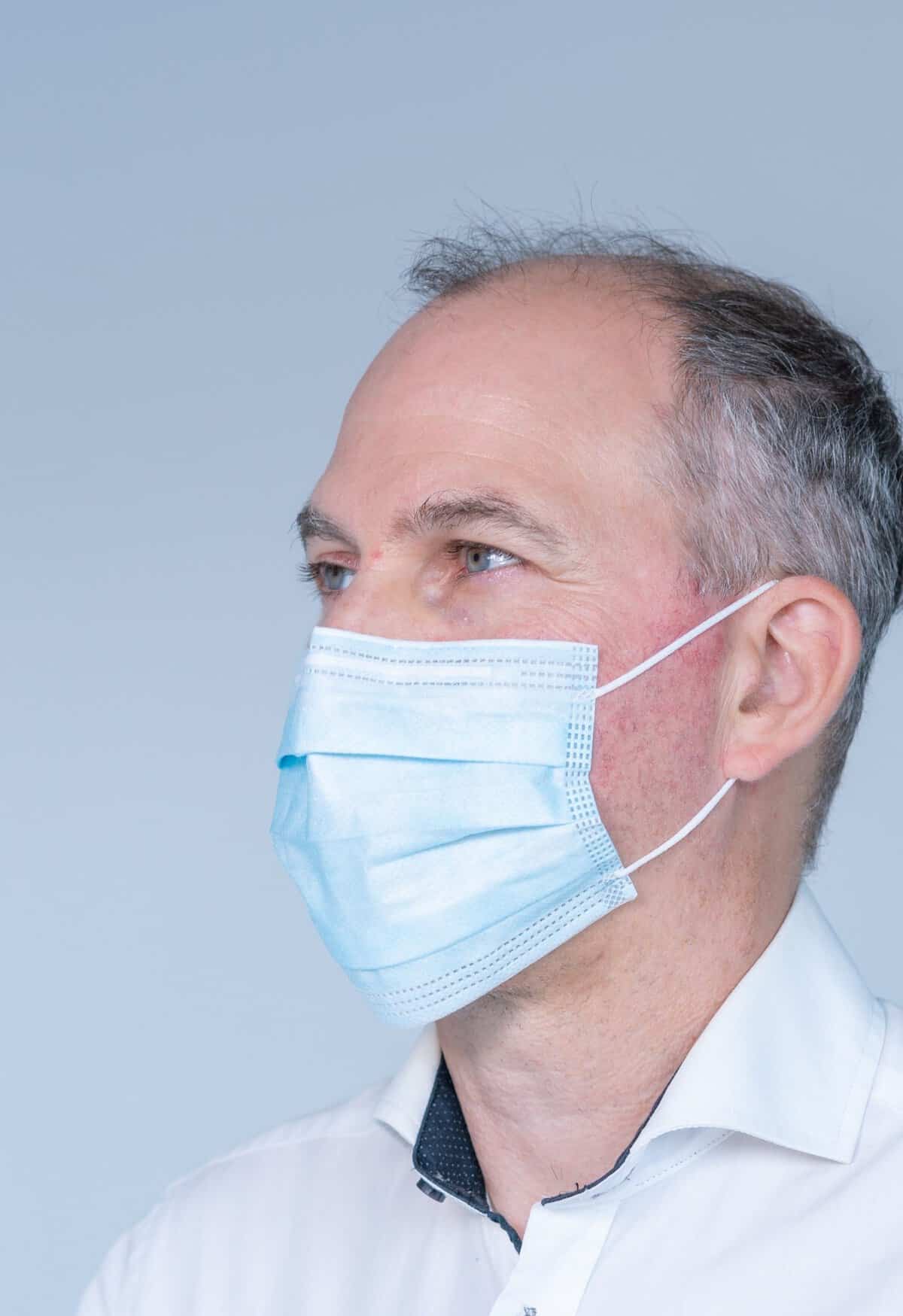 Man in a blue medical mask