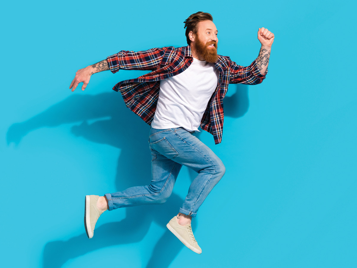 a man jumps in the air looking as if he is running