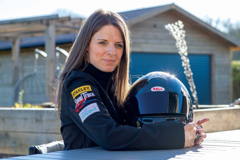 Nathalie McGolin holding a car racing helmet