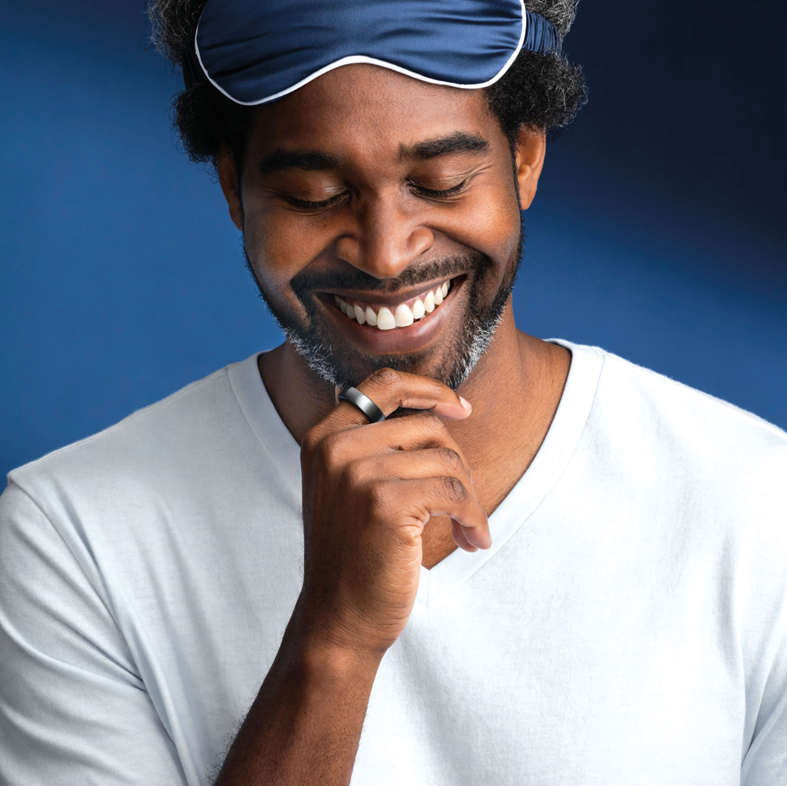 man smiling in a sleeping mask