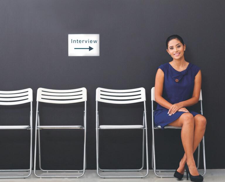 woman sitting in a row of chairs