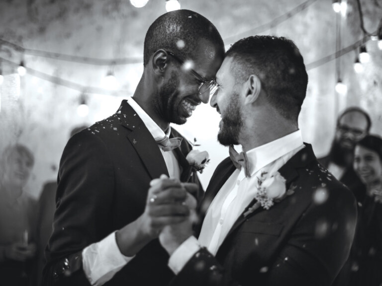 Two men dancing together at their wedding