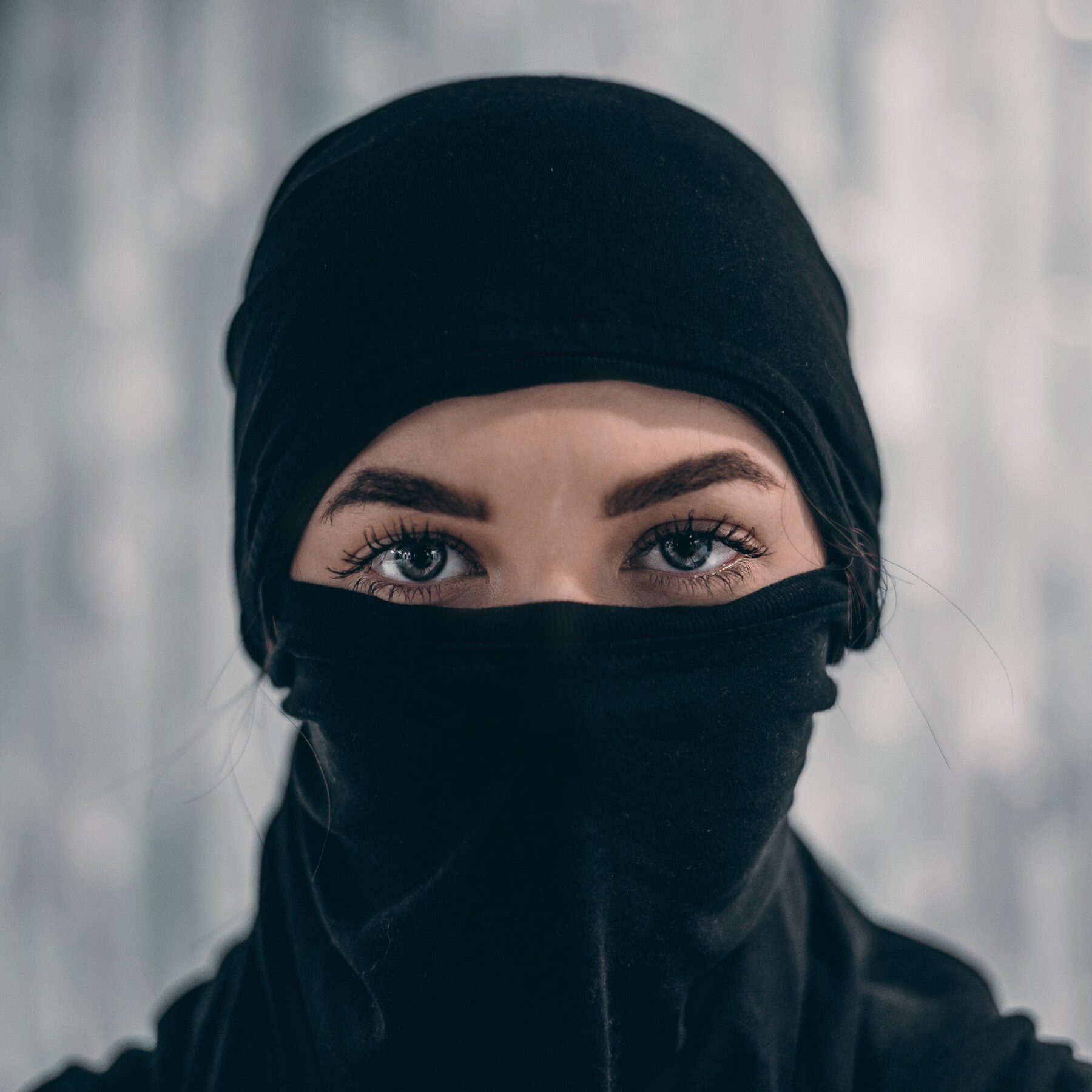 Girl wearing a full face mask with just her eyes showing
