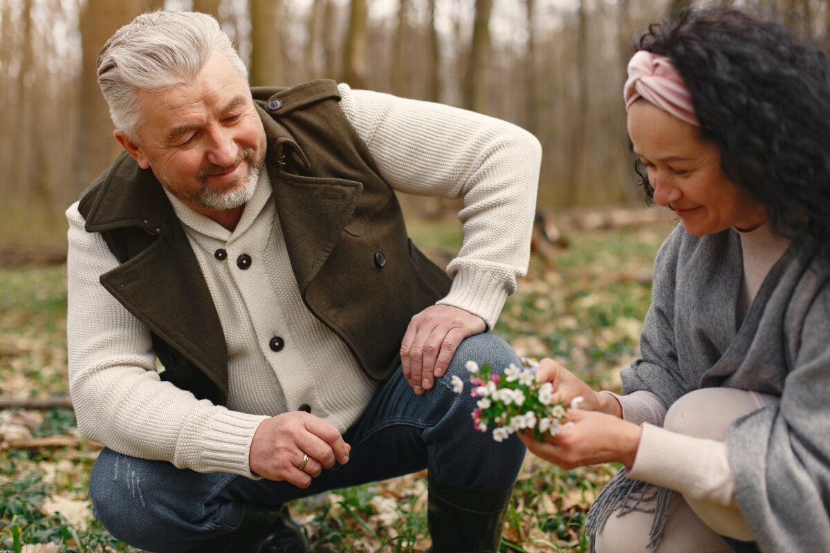 Man and a woman picking flowers