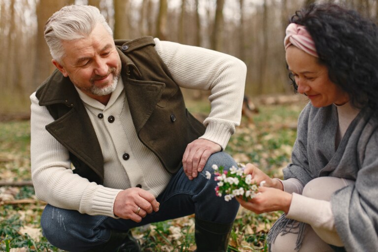 Man and a woman picking flowers