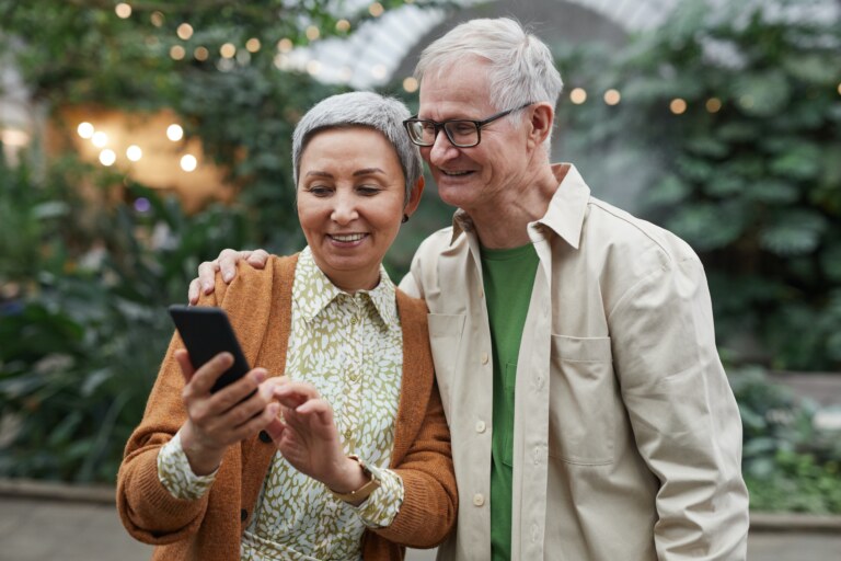 man and a woman looking at her phone