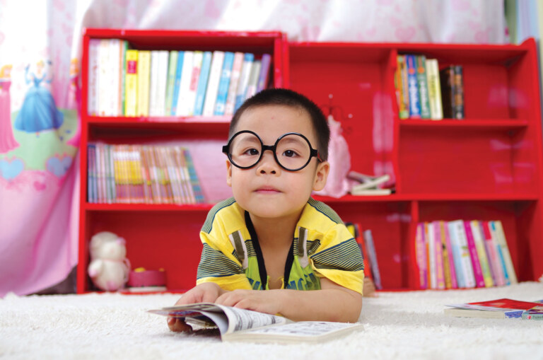 young boy wearing large glasses