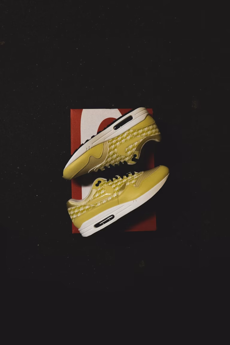 a pair of bright yellow running shoes on a box